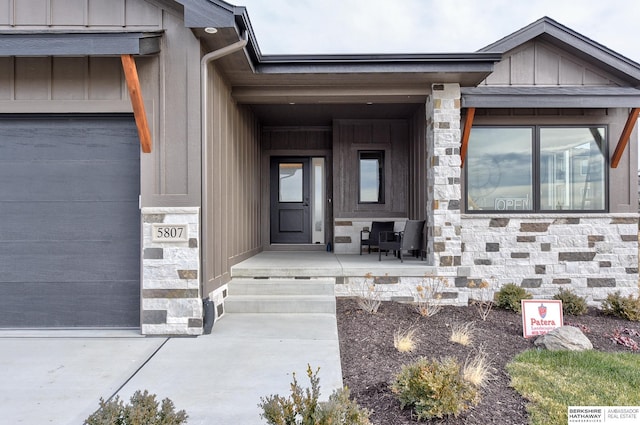 property entrance featuring a porch and a garage