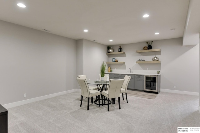 carpeted dining room featuring wine cooler and wet bar