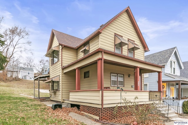 view of front facade with a front yard and a porch