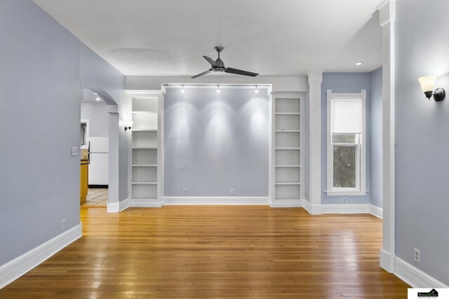 spare room with hardwood / wood-style floors and ceiling fan