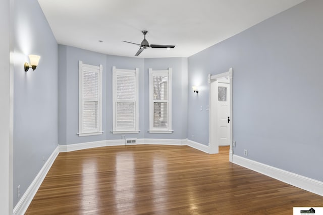 unfurnished room with ceiling fan and wood-type flooring