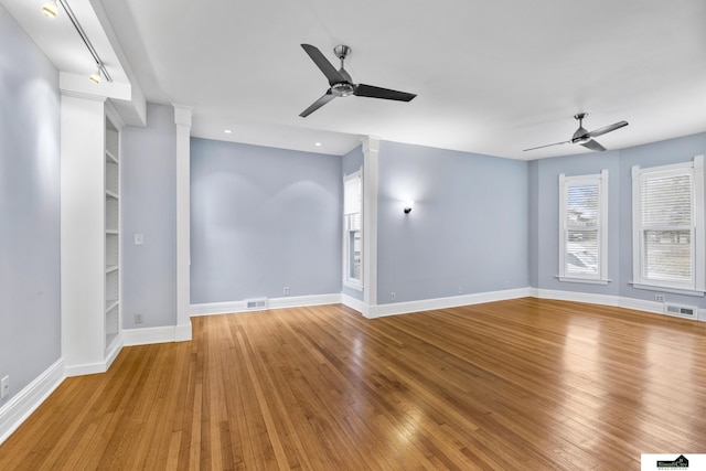 unfurnished living room with ceiling fan and wood-type flooring