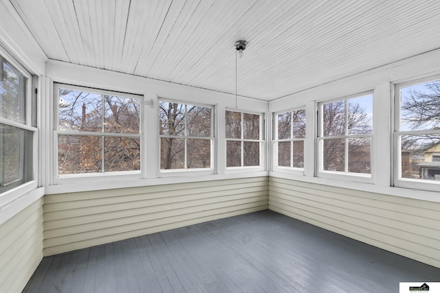 unfurnished sunroom with a wealth of natural light and wood ceiling