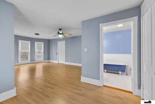 unfurnished living room featuring light hardwood / wood-style flooring and ceiling fan