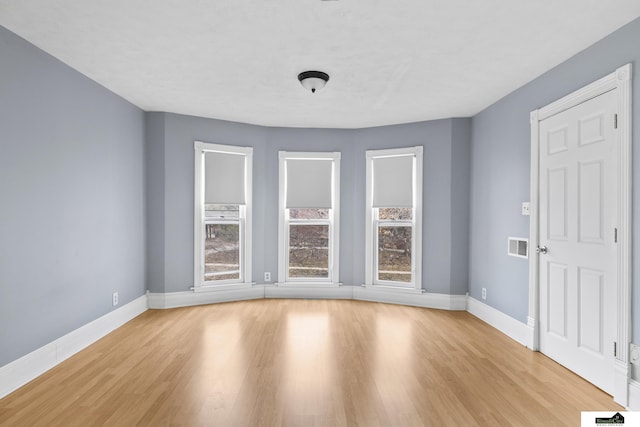 unfurnished room featuring light wood-type flooring