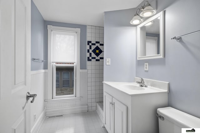 bathroom featuring tile patterned floors, vanity, and toilet