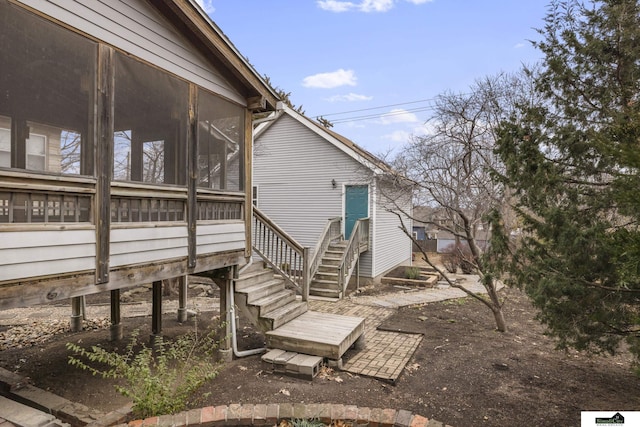 view of property exterior featuring a sunroom