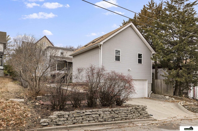 view of side of home featuring a garage