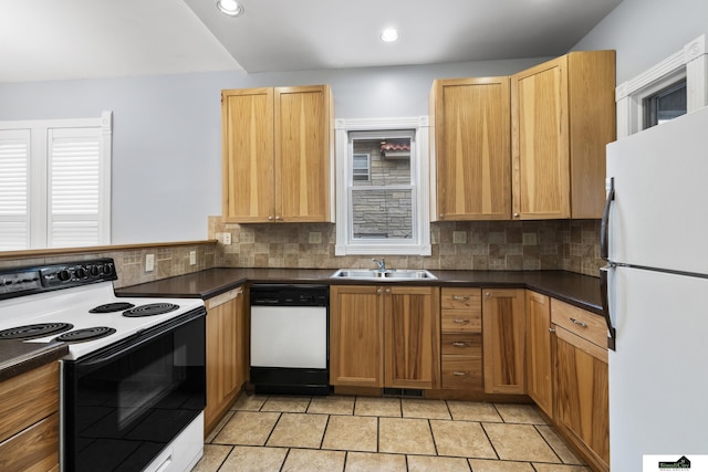 kitchen with tasteful backsplash, sink, and white appliances