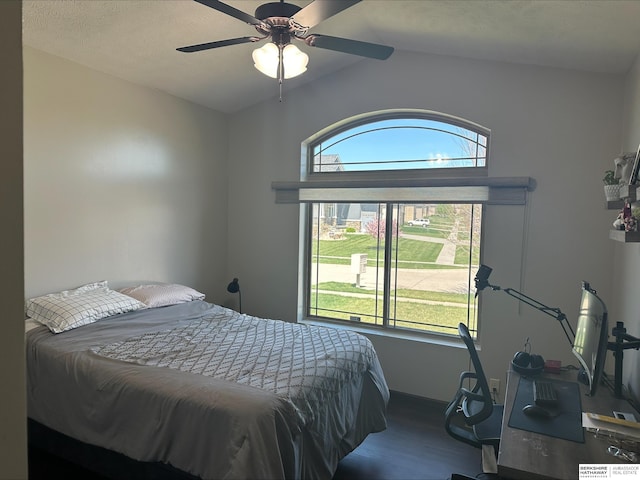 bedroom with multiple windows, ceiling fan, vaulted ceiling, and hardwood / wood-style flooring