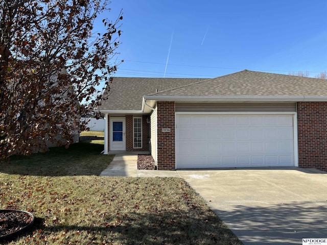 ranch-style house featuring a garage and a front yard