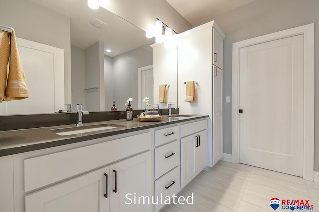 bathroom with tile patterned floors and vanity