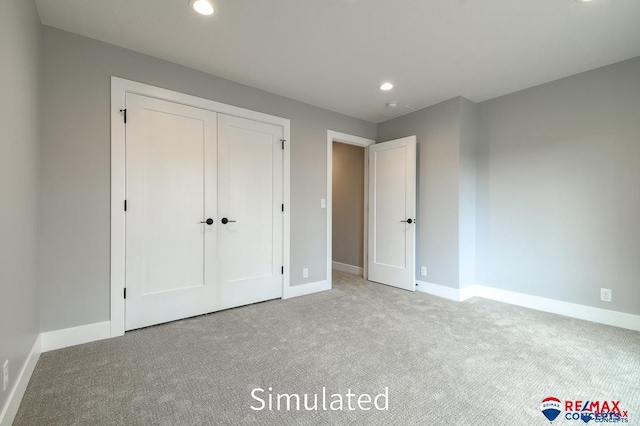 unfurnished bedroom featuring carpet and a closet