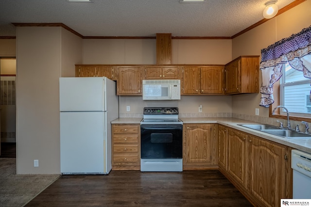 kitchen featuring sink, dark hardwood / wood-style floors, a textured ceiling, white appliances, and ornamental molding