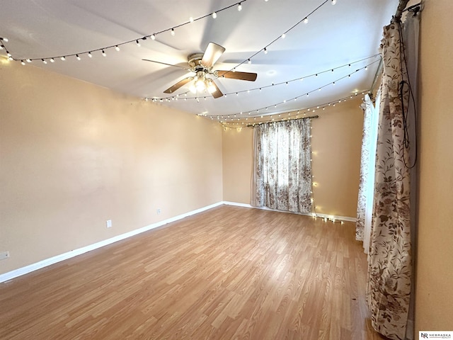 spare room featuring ceiling fan and light hardwood / wood-style flooring