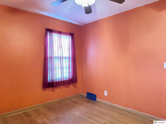 empty room with ceiling fan and wood-type flooring