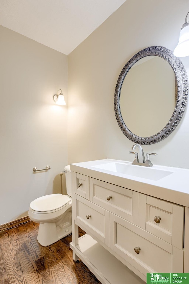 bathroom featuring vanity, toilet, and wood-type flooring