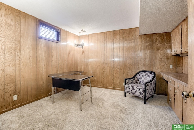 living area with wood walls and light colored carpet