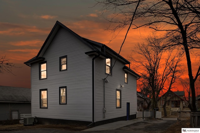 property exterior at dusk featuring central AC