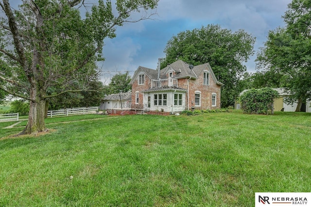 rear view of house featuring a yard