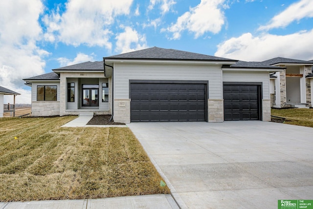 prairie-style house with a front yard and a garage