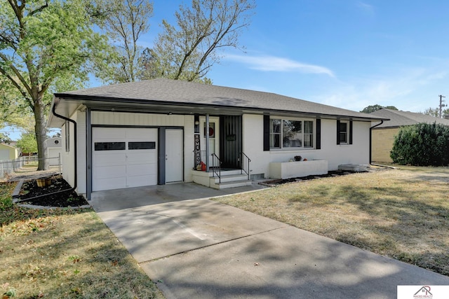 ranch-style home featuring a front yard and a garage