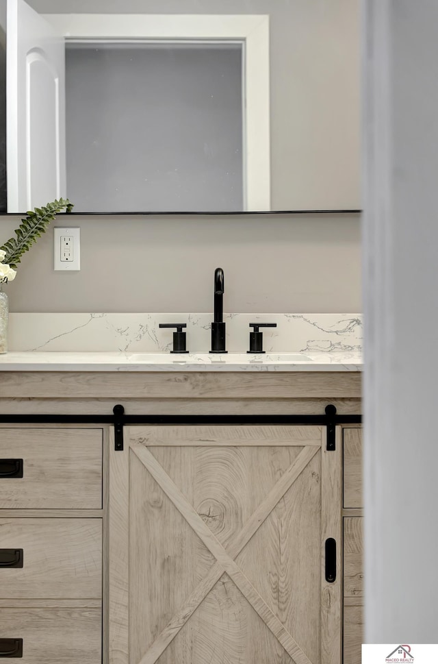 room details featuring a barn door and vanity