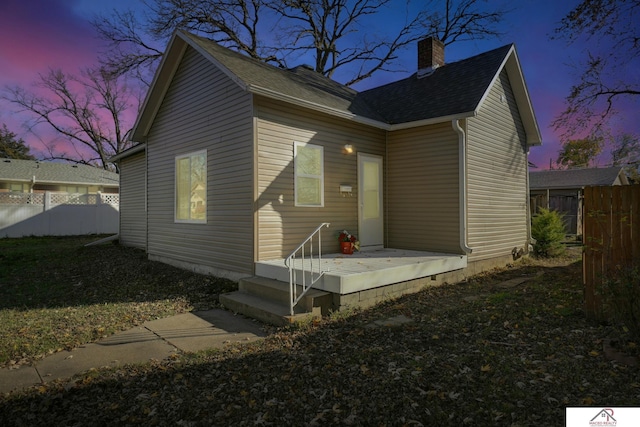 view of back house at dusk