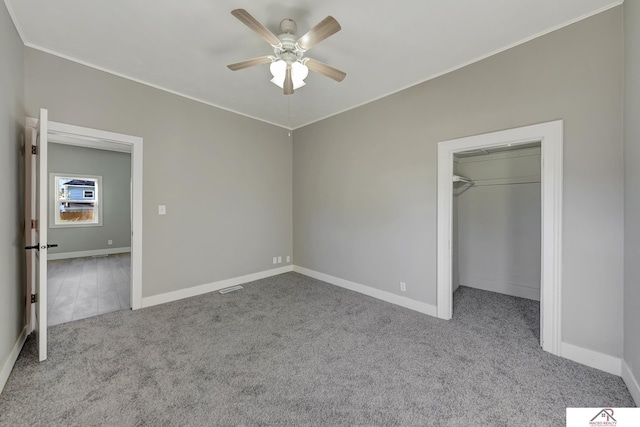 unfurnished bedroom with ceiling fan, a closet, and light colored carpet