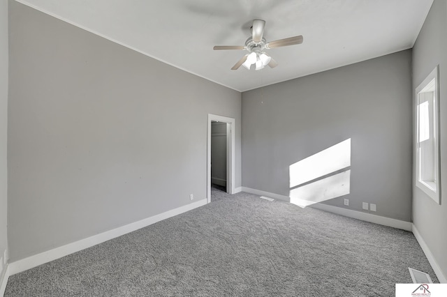 spare room featuring carpet and ceiling fan