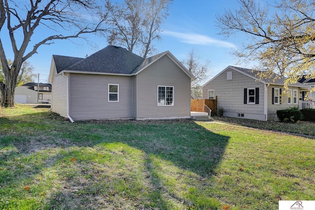 rear view of property featuring a yard