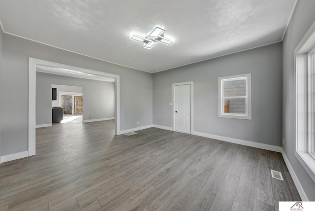 spare room featuring a textured ceiling and hardwood / wood-style flooring