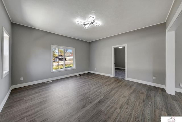 empty room with dark wood-type flooring