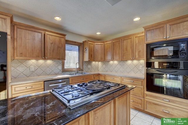 kitchen with black appliances, sink, decorative backsplash, dark stone countertops, and light tile patterned floors