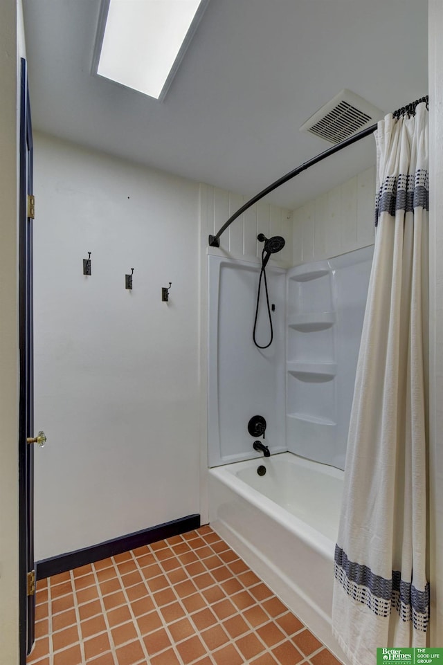 bathroom featuring tile patterned floors and shower / bath combo with shower curtain