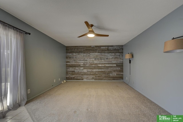 spare room featuring light tile patterned floors and ceiling fan