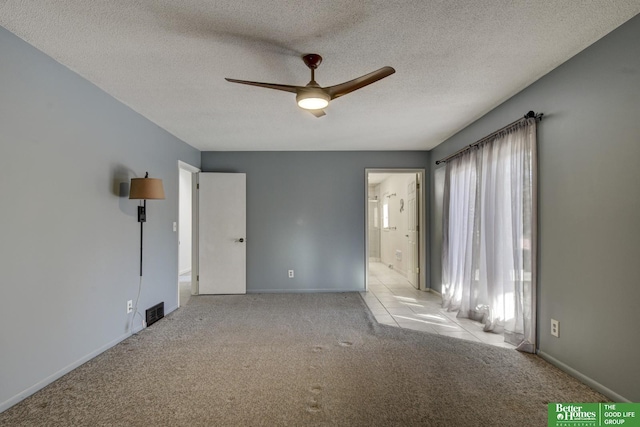 carpeted empty room featuring a textured ceiling and ceiling fan