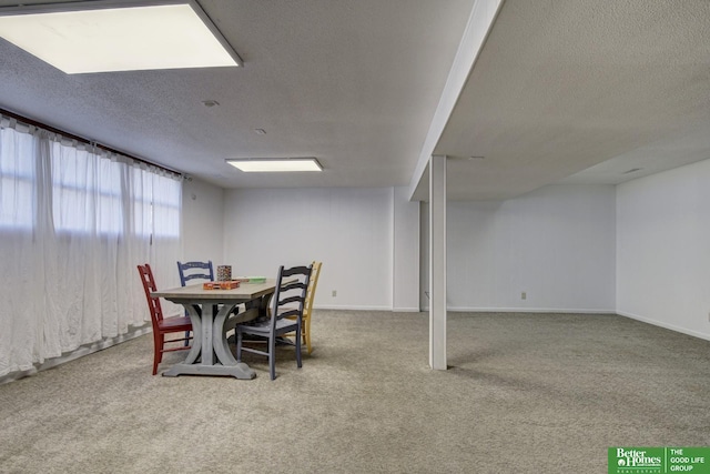 dining space featuring carpet flooring and a textured ceiling