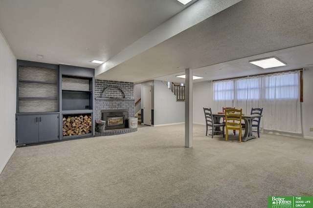 basement with a textured ceiling and a brick fireplace