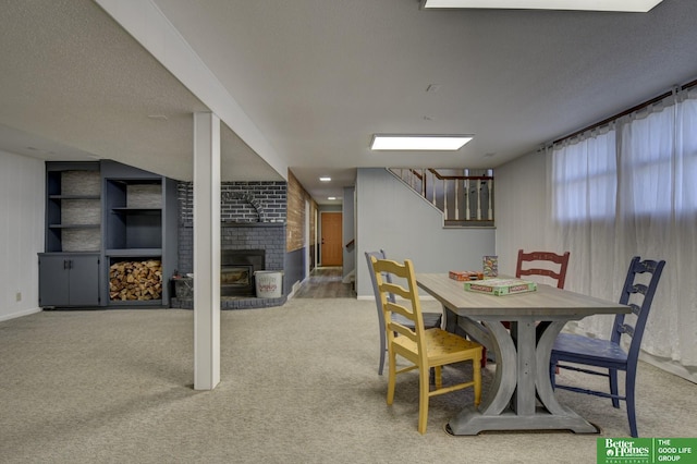 carpeted dining space featuring a textured ceiling and a wood stove