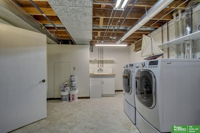 washroom with washer and dryer and sink