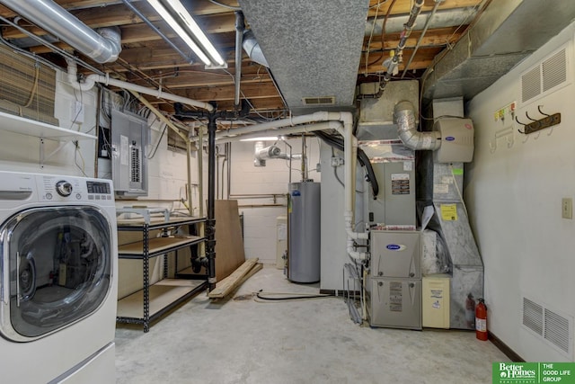 basement featuring gas water heater, washer / dryer, electric panel, and heating unit