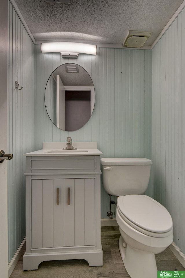 bathroom with hardwood / wood-style floors and wood walls