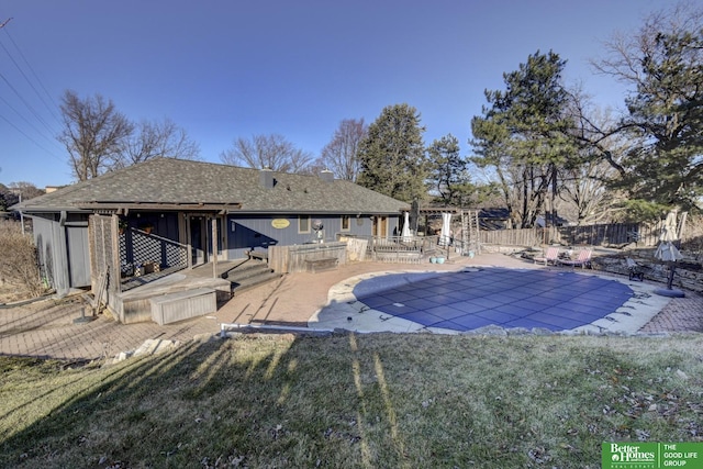 view of pool with a patio and a lawn