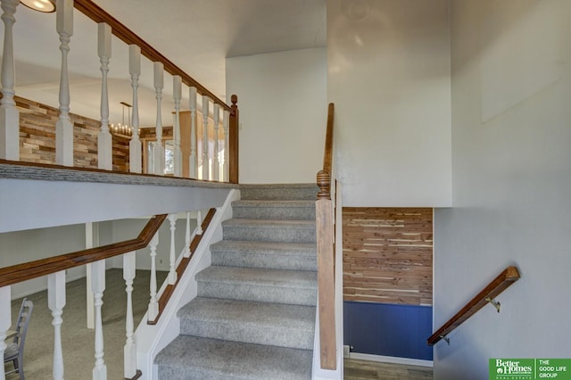 stairway with carpet and a chandelier