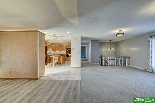 interior space featuring a textured ceiling and light wood-type flooring