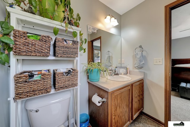 bathroom featuring vanity and toilet