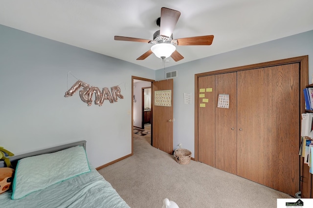 bedroom featuring a closet, ceiling fan, and light colored carpet