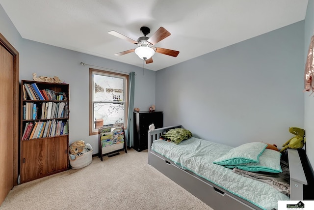 bedroom featuring light colored carpet and ceiling fan