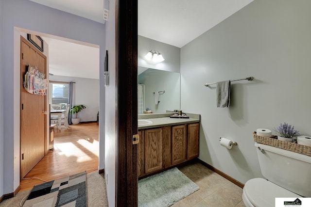 bathroom featuring hardwood / wood-style flooring, vanity, and toilet